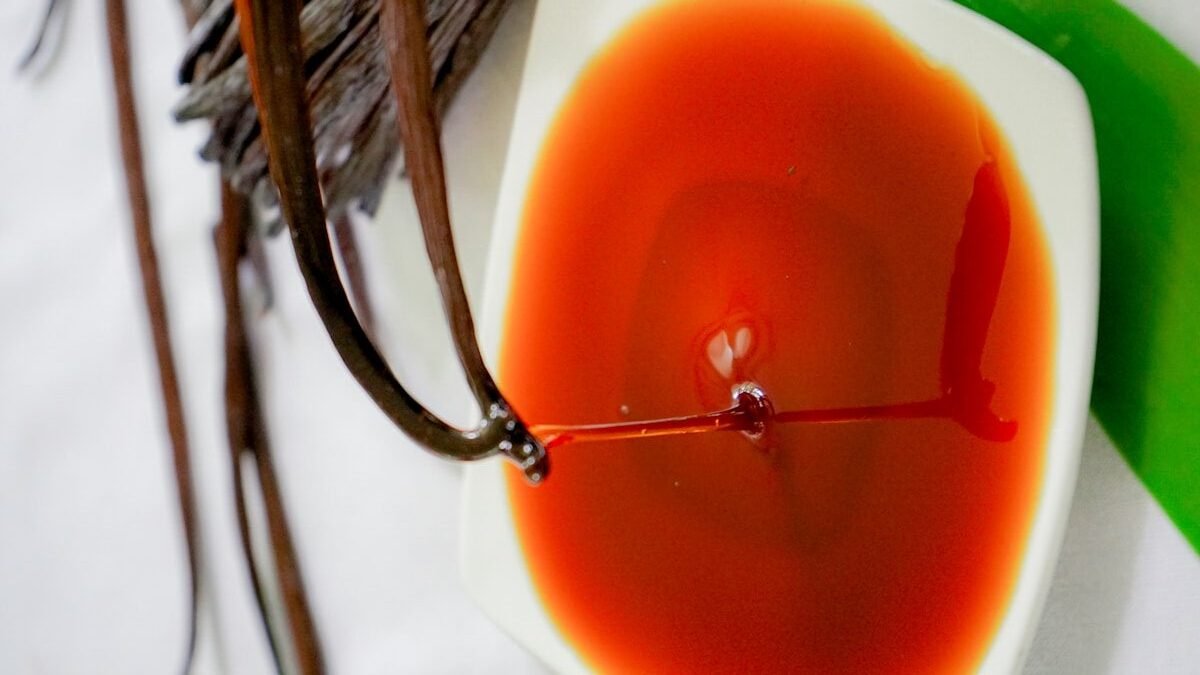 a small white plate with a red sauce on it